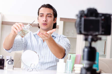 Young handsome man recording his blog in hygiene conceptの写真素材