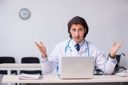 Young handsome doctor working in the clinicの写真素材