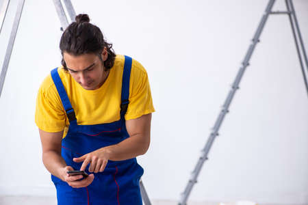 Young man contractor doing renovation at homeの写真素材