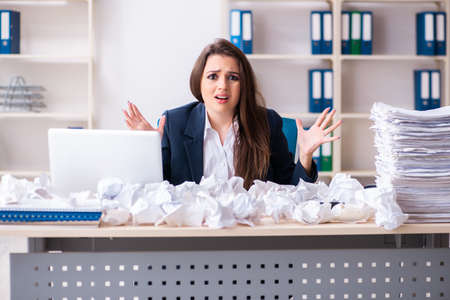 Businesswoman rejecting new ideas with lots of papersの写真素材