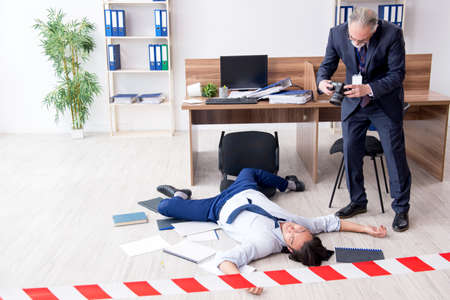 Forensic investigator and dead employee in the officeの写真素材