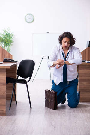 Young male employee unhappy with excessive workの写真素材