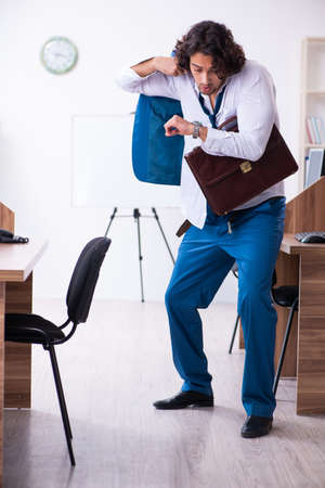 Young male employee unhappy with excessive workの写真素材