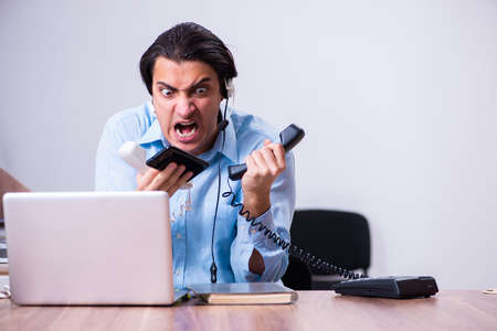 Call center operator working at his deskの写真素材