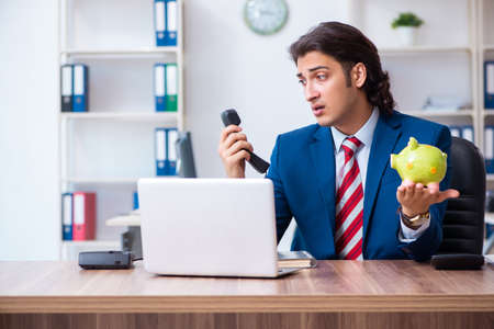 Young male businessman working in the officeの写真素材