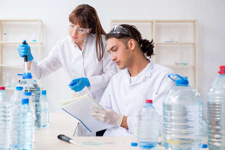 Two chemists working in the lab