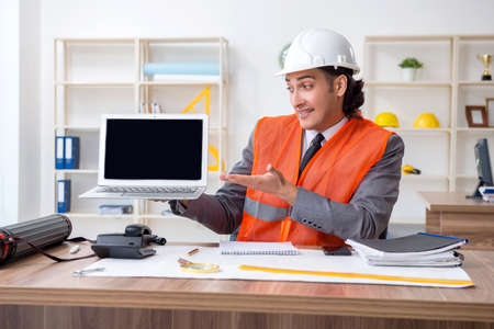 Young male architect working in the office