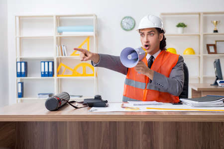 Young male architect working in the office