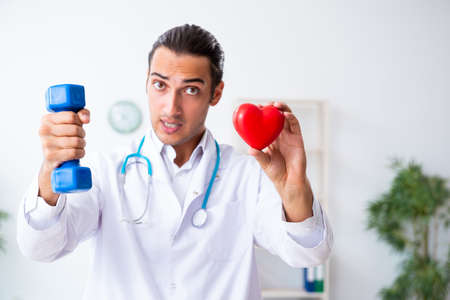Young male doctor in sport and dieting conceptの写真素材