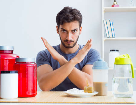 Athlete tasting new protein supplements for better musclesの写真素材