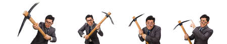 Young businessman holding a tool isolated on whiteの写真素材