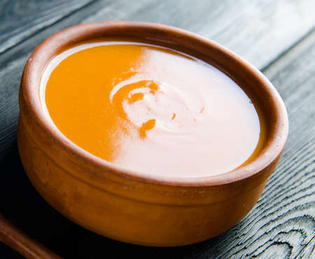 Carrot soup served on the table in bowlの写真素材