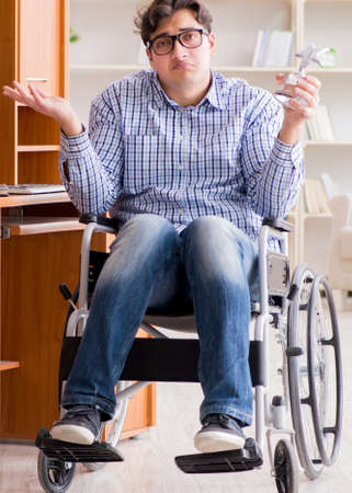 The disabled student studying at home on wheelchairの写真素材