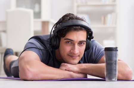 Man doing sports at home and listening to music