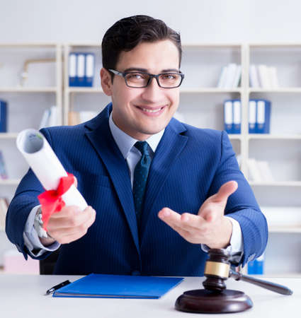 Laywer with diploma roll in legal profession eductional conceptの写真素材