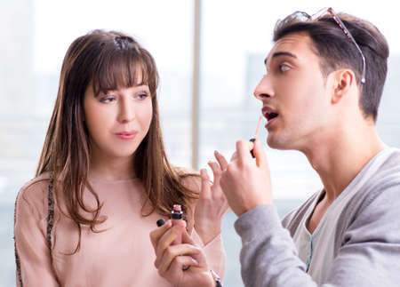 Man doing make-up for cute woman in beauty salon