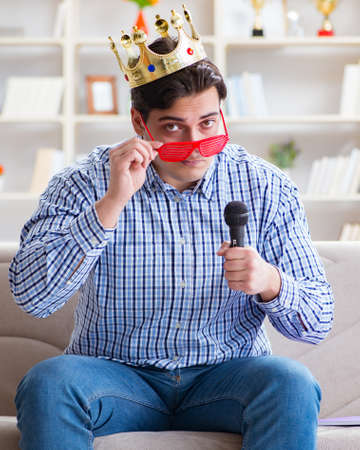 The funny man singing songs in karaoke at homeの写真素材