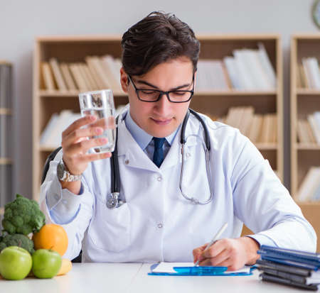 Scientist studying nutrition in various foodの写真素材