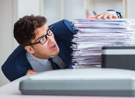 The businessman making copies in copying machine