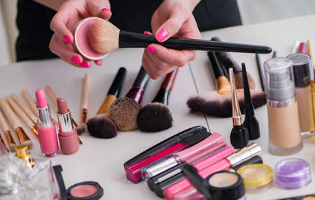 Collection of make up products displayed on the tableの写真素材