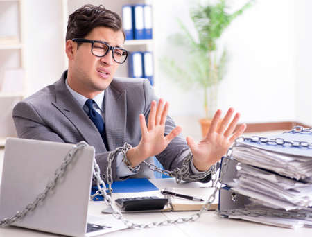 Busy employee chained to his office desk