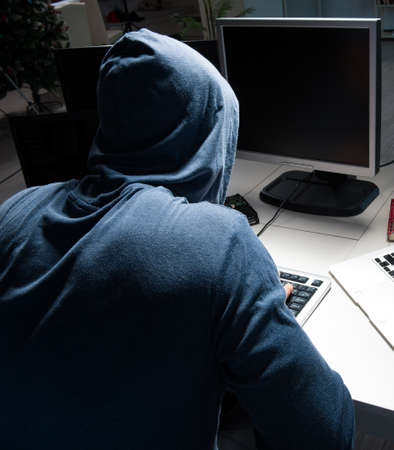 Hacker hacking computer at night