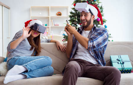 Happy family using virtual reality VR glasses during christmas