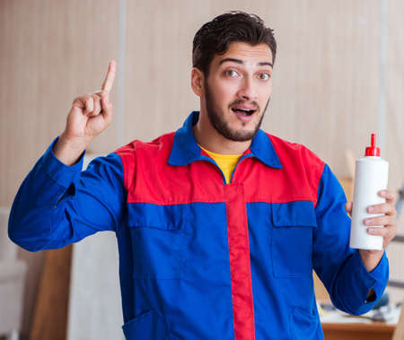 Yooung repairman carpenter working with paint painting