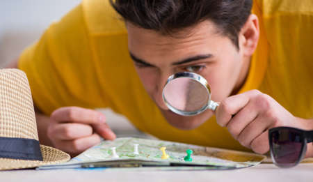 Man planning his vacation trip with map