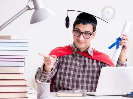 Super hero student wearing a mortarboard studyingの写真素材