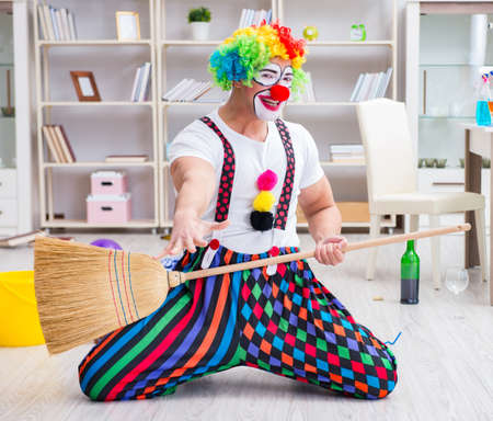 Funny clown doing cleaning at home