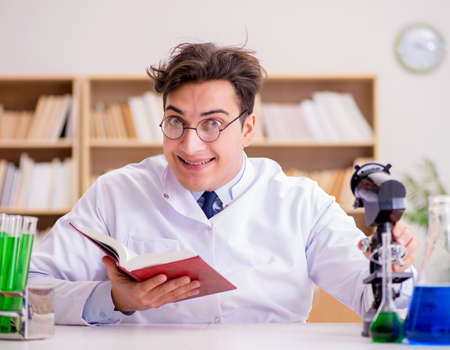 Mad crazy scientist doctor doing experiments in a laboratoryの写真素材