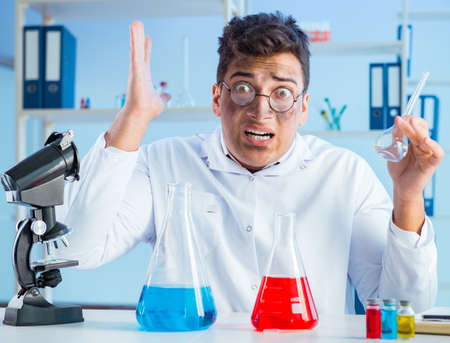 Funny mad chemist working in a laboratoryの写真素材