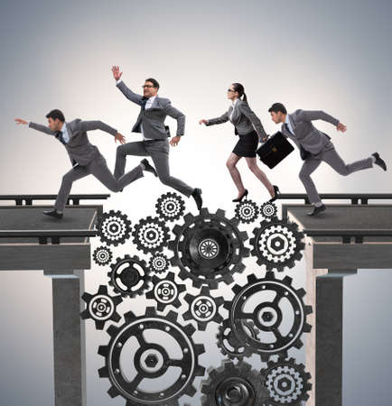 Business people crossing the bridge with cogwheelsの写真素材