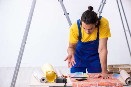 Young man contractor doing renovation at homeの写真素材