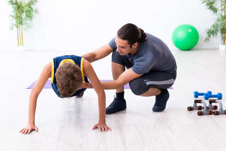 Young father and his son doing exercisesの写真素材