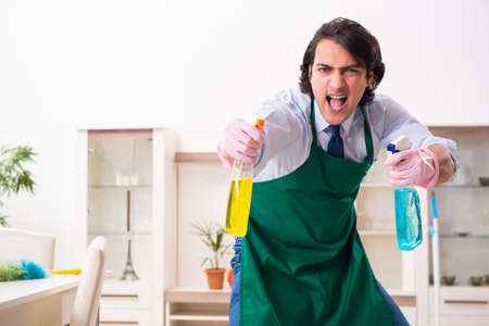 Young businessman cleaning the house