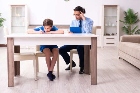 Busy father helping his son to prepare for examの写真素材