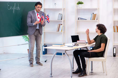 Male english teacher and student in the classroomの写真素材