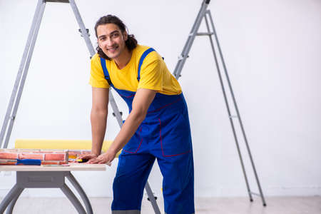 Young man contractor doing renovation at homeの写真素材