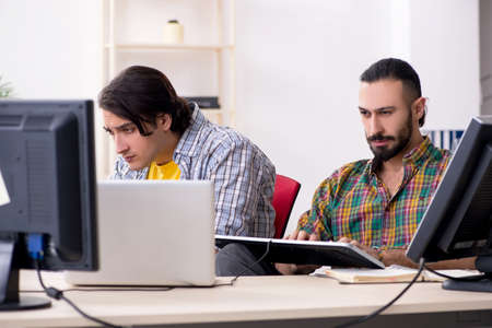 Two it specialists working in the officeの写真素材