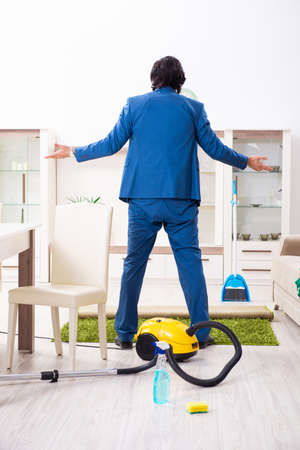 Young businessman cleaning the houseの写真素材