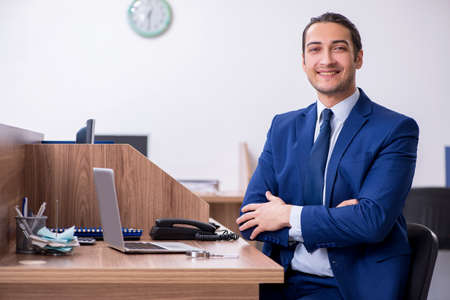 Young handsome businessman working in the officeの写真素材