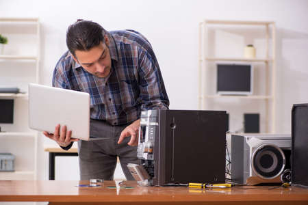Young engineer repairing musical hi-fi system