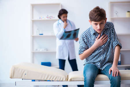 Male radiologist looking at boys imagesの写真素材