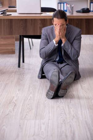 Unhappy male businessman in the officeの写真素材