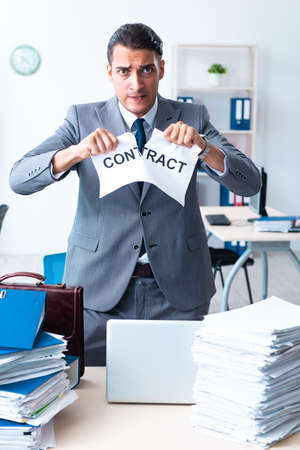 Businessman with heavy paperwork workloadの写真素材