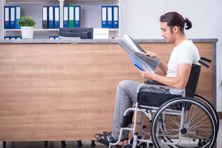 Young man at hospital reception desk