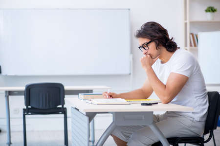 Young male student in front of whiteboardの写真素材