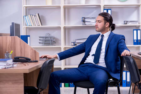 Young handsome businessman working in the officeの写真素材